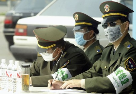 Health Department officers check vehicles at a check point on the outskirts of Beijing, 30 May 2003. Beijing, the worst affected city in the world from the SARS outbreak, has seen record lows from the disease in the last week with only three cases reported on May 29. AFP PHOTO/Peter PARKS (Photo credit should read PETER PARKS/AFP/GettyImages)