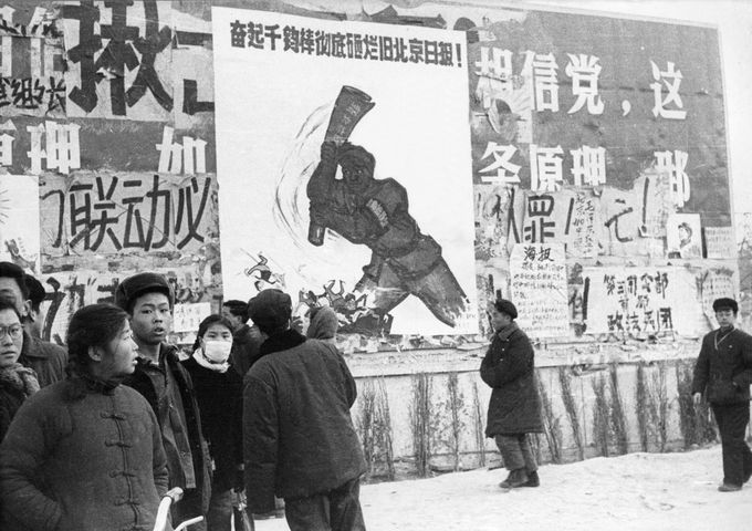 BEIJING, CHINA - JANUARY21: A small group of Chinese youths walk past several dazibaos, the revolutionary placards, in February 1967 in downtown Beijing, during the 'Great Proletarian Cultural Revolution'. Since the the cultural revolution was launched in May 1966 at Beijing University, Mao's aim was to recapture power after the failer of the 'Great Leap Forward'. (Photo credit should read JEAN VINCENT/AFP/Getty Images)