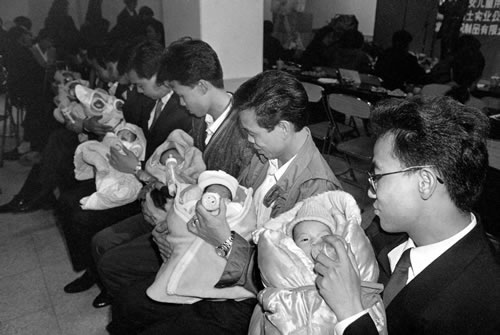 Молодые папы учатся кормить детей молоком. Фото: Великая Эпоха.