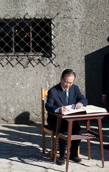 Китайский премьер Вэнь Цзябао расписывается в книге для посетителей в музее Аушвиц в Освенциме, Польша, 27 апреля. Он написал: «Зная историю, мы можем строить планы на будущее». Фото: Pawel Ulatowski/AFP/Getty Images