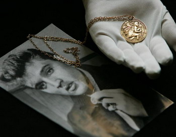 Фото Элвиса Пресли и медальон святого Христофора, который Элвис носил во время съемок фильма Jailhouse Rocк режиссера Ричарда Торпа в 1957 году. Фото: ADRIAN Деннис / AFP / Getty Images