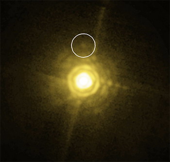 Родительская звезда и изученная планета (в кружке) в изображении с прибора NACO (фото ESO/M. Janson).