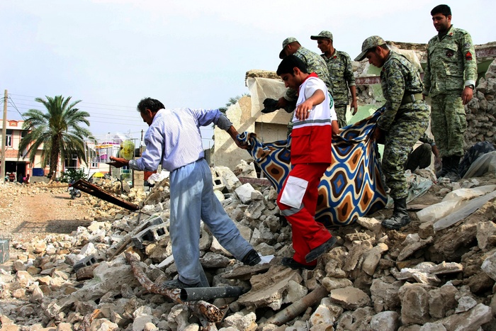 Иранские солдаты помогают жителям собрать вещи после землетрясения магнитудой 6,1 баллов вблизи портового города Бушер 10 апреля 2013 г. Фото: STR/AFP/Getty Images