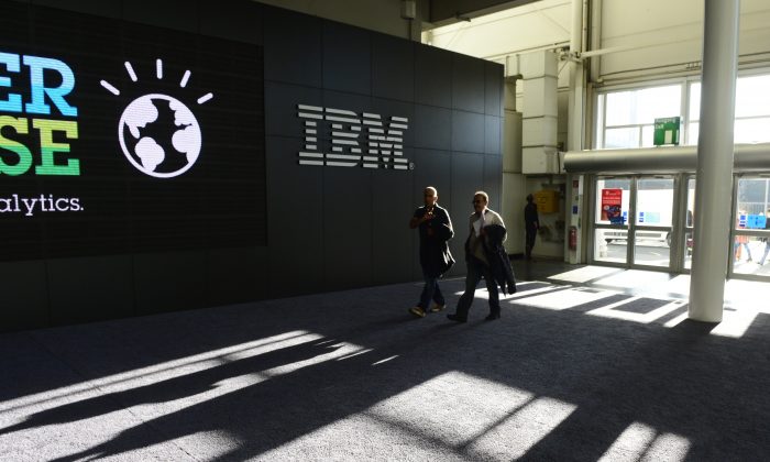 Мужчины проходят мимо стенда IBM накануне старта выставки технологий CeBIT 2014, 9 марта 2014 года в Ганновере, центральная Германия. (Джон МакДугалл / AFP / Getty Images) | Epoch Times Россия