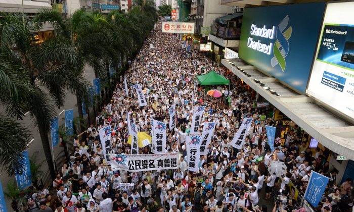 Масса протестующих марширует по улицам Гонконга в поддержку всеобщего избирательного права 1 июля. Марш стал традицией с 2003 года, когда коммунистические власти в Китае попытались принять скандальный закон о борьбе с подстрекательством к мятежу. (Сун Сянглонг / Великая Эпоха) | Epoch Times Россия
