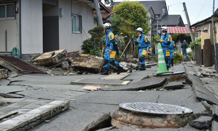 Полицейские ищут пропавших без вести в пострадавшем районе после двух землетрясений в районе Машики, префектура Кумамото, Япония, 17 апреля 2016 г. (Kazuhiro Nogi / AFP / Getty Images) | Epoch Times Россия