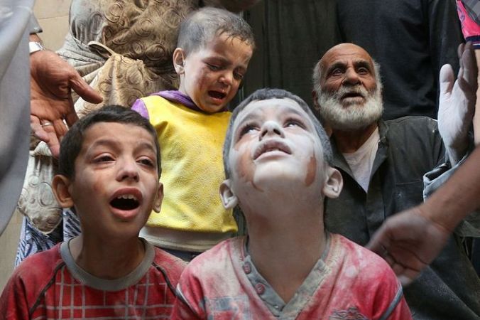 Сирийские дети плачут во время авиаударов  в Алеппо, Сирия, 11 октября, 2016 год. Фото: THAER MOHAMMED/AFP/Getty Images | Epoch Times Россия