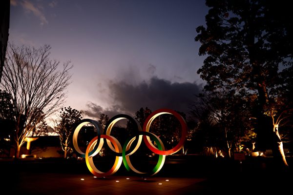 Олимпийские кольца видны рядом с Национальным стадионом, основным местом проведения Олимпийских и Паралимпийских игр в Токио в 2020 году, Токио, 8 января 2021 года. BEHROUZ MEHRI/AFP via Getty Images | Epoch Times Россия