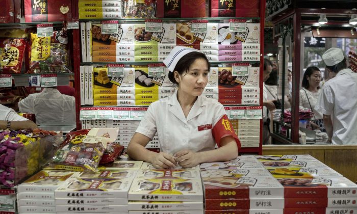 Продавец из Китая ждет покупателей в магазине 28 августа 2015 года в Пекине, Китай. (Кевин Фрайер / Getty Images) | Epoch Times Россия