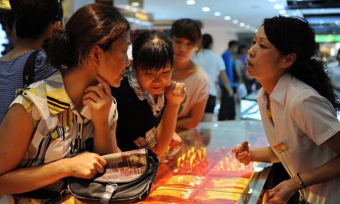 Покупатели рассматривают золотые украшения в магазине в Хэфэе, провинция Аньхой на востоке Китая, 23 августа 2010 г. (STR / AFP / Getty Images) | Epoch Times Россия