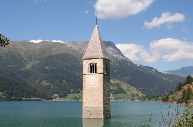 С начала 1950-х годов только лишь колокольня церкви деревни Кюрон в Италии выглядывала из воды озера. (Crédit : Adrian Michael) | Epoch Times Россия