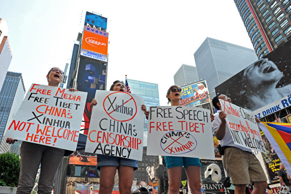 Студенты протестуют против электронных рекламных экранов Агентства «Синьхуа» на Таймс-сквер. Фото: STAN HONDA / AFP / Getty Images | Epoch Times Россия