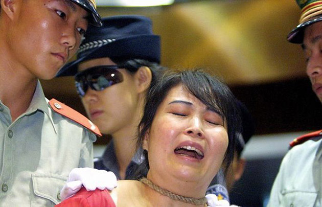 Осужденная разносчик наркотиков Ван Сюнъинь терпит поражение, поскольку ее приговорили к смертной казни за продажу 200 граммов героина за 27 000 юаней еще в 1999 году в Гуанчжоу, 26 июня 2003 года, когда Китай отмечает Международный день борьбы с наркотиками. (STR / AFP / Getty Images) | Epoch Times Россия
