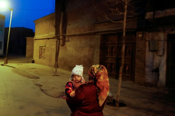 Женщина с ребёнком в старом городе Кашгара. 23 марта 2017 года Синьцзян-Уйгурский автономный район, Китай. Thomas Peter/Reuters | Epoch Times Россия