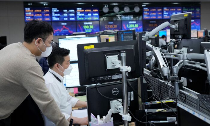 Валютные трейдеры смотрят на мониторы в дилинговом зале по обмену валюты в главном офисе банка KEB Hana в Сеуле, Южная Корея, 3 марта 2022 года. (AhnYoung-joon/AP Photo) | Epoch Times Россия