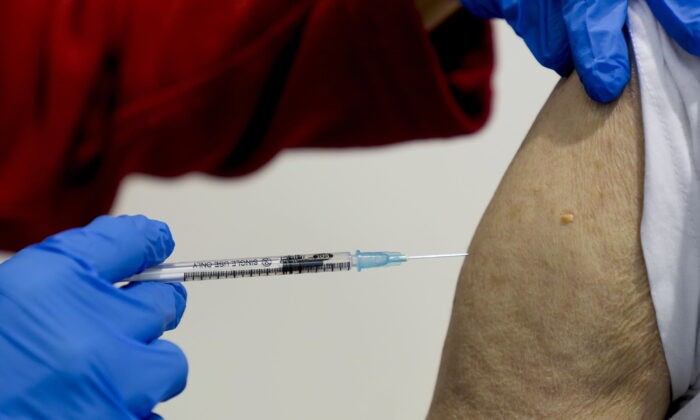 87-летний мужчина делает прививку в центре вакцинации во Франкфурте, Германия, 11 ноября 2021 года. (Michael Probst/AP Photo)
 | Epoch Times Россия