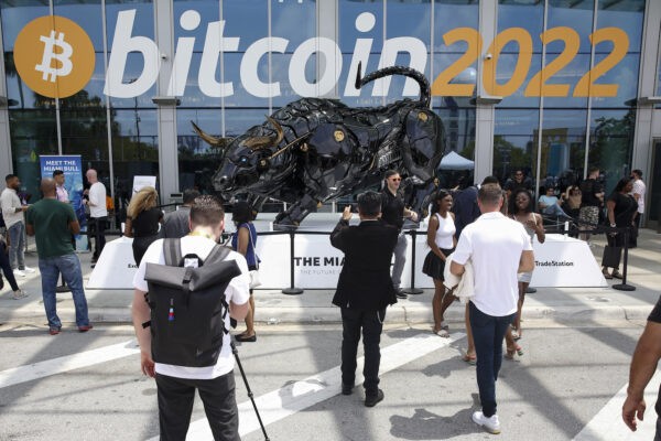 MIAMI, FLORIDA - APRIL 7: Attendees pose for photos in front of The Miami Bull during the Bitcoin 2022 Conference at Miami Beach Convention Center on April 7, 2022 in Miami, Florida. The worlds largest bitcoin conference runs from April 6-9, expecting over 30,000 people in attendance and over 7 million live stream viewers worldwide.(Photo by Marco Bello/Getty Images)