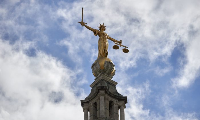 «Леди правосудия», статуя из сусального золота высотой 12 футов, изображена на вершине купола Центрального уголовного суда, обычно называемого Олд Бейли, в центре Лондона 21 августа 2016 года. (Niklas Halle’n/AFP/Getty Images)
 | Epoch Times Россия