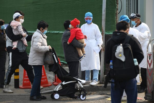Люди ждут у входа в детскую больницу в Пекине, Китай, 31 марта 2020 года. (GREG BAKER/AFP via Getty Images)