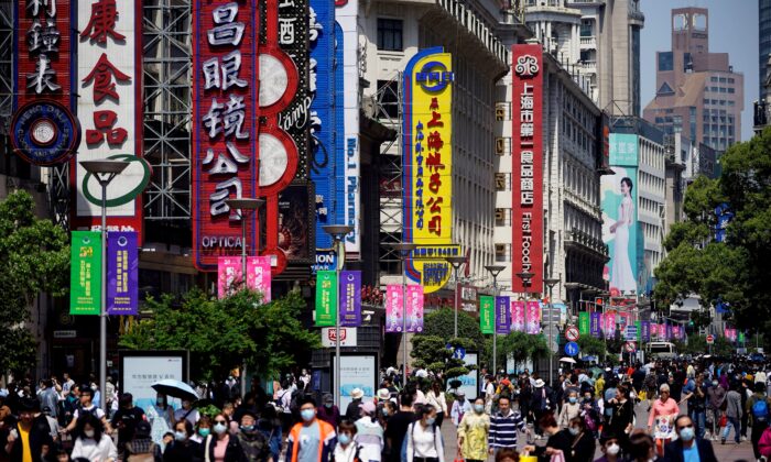 Люди идут по Нанкинской пешеходной улице, главному торговому району Шанхая, 5 мая 2021 года. (Aly Song/Reuters)
 | Epoch Times Россия