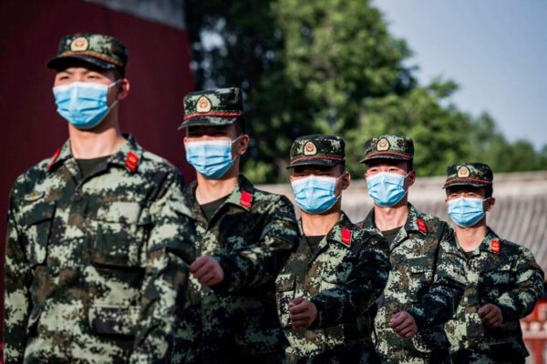 Солдаты Народно-освободительной армии Китая (НОАК) маршируют у входа в Запретный город (слева) в Пекине 22 мая 2020 года. (Nicolas Asfouri/AFP via Getty Images)