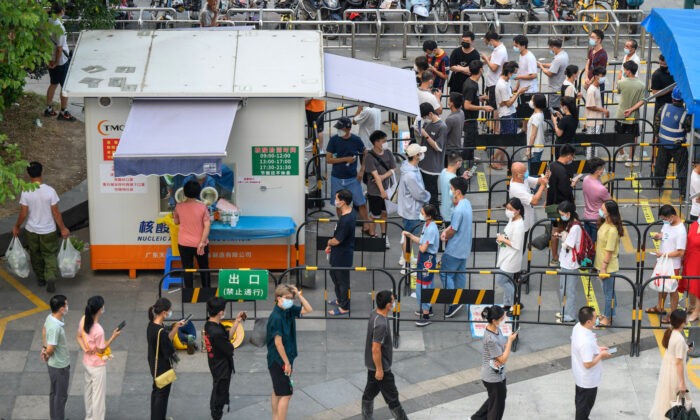 Люди стоят в очереди, чтобы пройти ПЦР-тестирование на COVID-19 в пункте сбора мазков в Гуанчжоу, провинция Гуандун на юге Китая, август 2022 года. (STR/AFP via Getty Images)
 | Epoch Times Россия