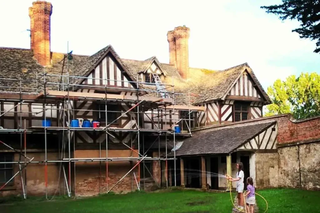 Члены семьи поливают лужайку во время ремонта. (Courtesy of Pitchford Estate) Супруги купили заброшенный 500-летний дом — и вот какой он стал после грандиозного ремонта