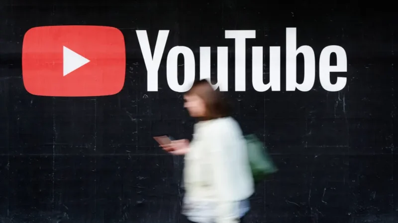 Google удаляет 11 000 каналов YouTube, связанных с Китаем и Россией Молодая женщина со смартфоном проходит мимо рекламного щита YouTube в Берлине, Германия, 27 сентября 2019 года. (Sean Gallup/Getty Images)