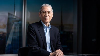 Портрет Гордона Чанга, китайского аналитика и эксперта EpochTV, на фоне панорамы города.