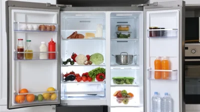 Открытый двухдверный холодильник, наполненный свежими продуктами
